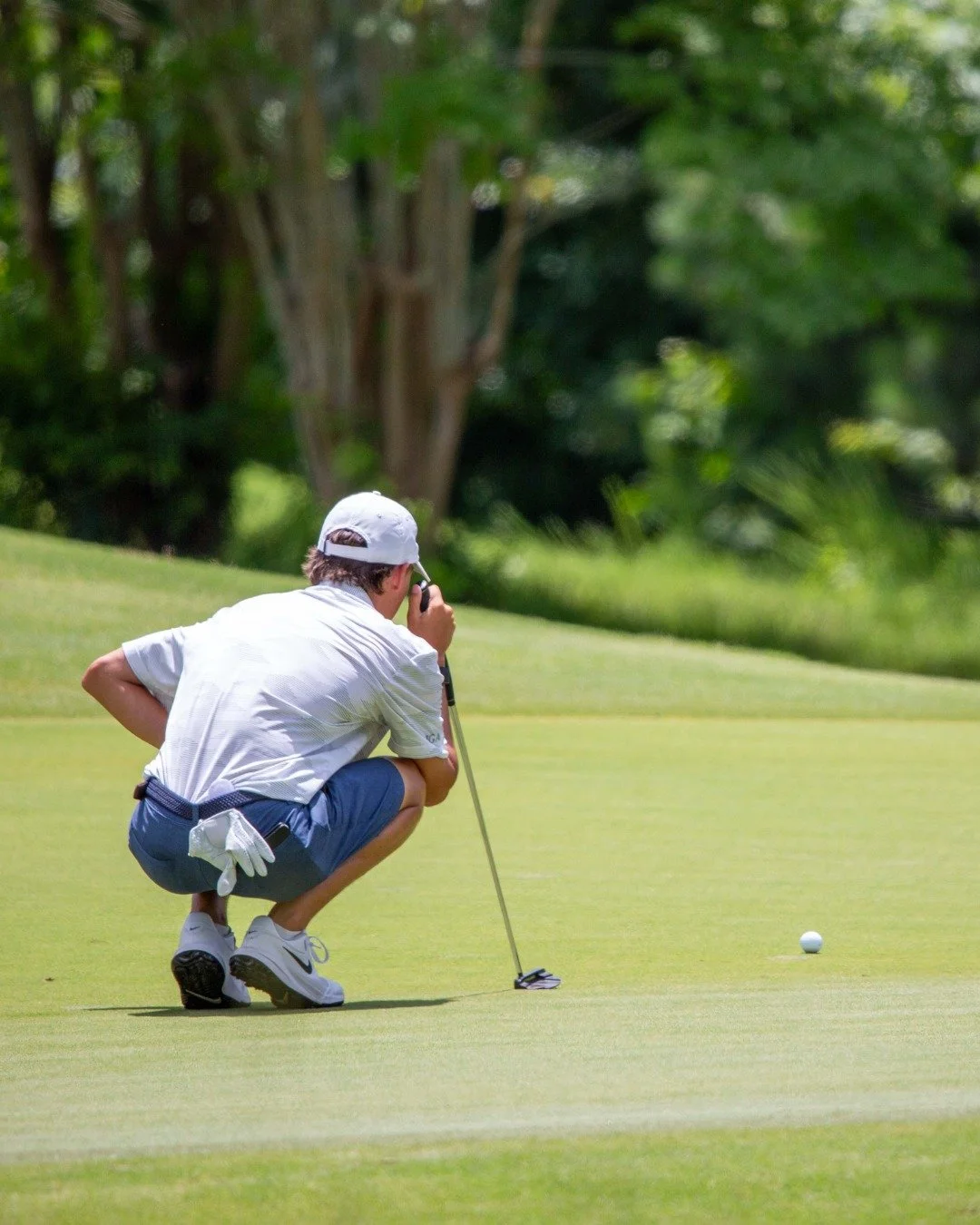 A golfer practising on the putting green