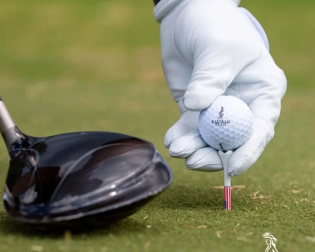 A ball teed up ready to be struck